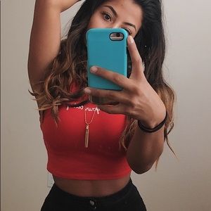 Red fitted crop top with a cursive “Not Your Baby”